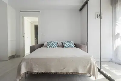 a bedroom with a large bed with two pillows on it at Reinapart Patacona Beach 46 in Valencia