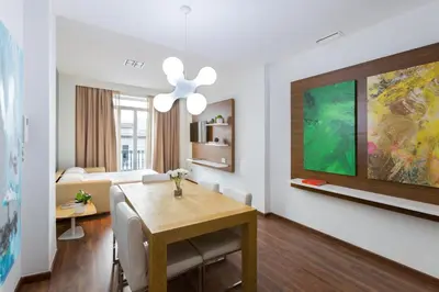 a dining room with a dining table and a living room at Center City Flats in Valencia