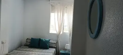 a room with a bed with a chair and a mirror at SUNSET ROOM AT FRONT BEACH - HABITACION EN LA PLAYA en Piso compartido in Tavernes de Valldigna