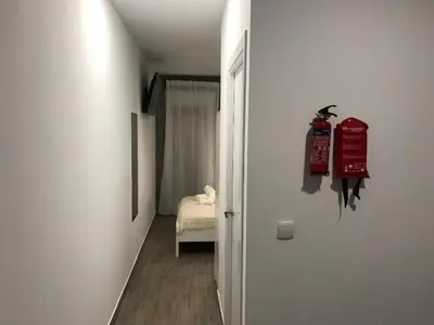 a hallway with a room with a fire hydrant on the wall at Pequeño Alojamiento con Mini Piscina - NO climatizada in Valencia
