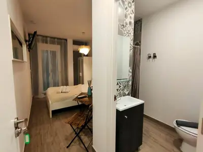 a bathroom with a sink and a bed in a room at Pequeño Alojamiento con Mini Piscina - NO climatizada in Valencia