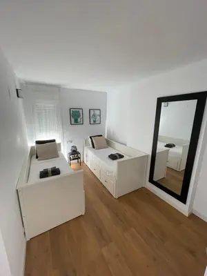 a white room with a bed and a mirror at Canet De Berenguer, Playa Apto con 2 habitaciones in Valencia