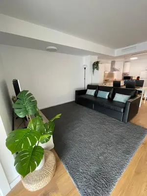 a living room with a black couch and a plant at Canet De Berenguer, Playa Apto con 2 habitaciones in Valencia