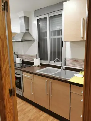 a kitchen with a sink and a stove at Precioso y gran apartamento en Cullera in Cullera