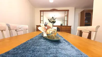 a dining room table with a gold helmet on it at Precioso y gran apartamento en Cullera in Cullera
