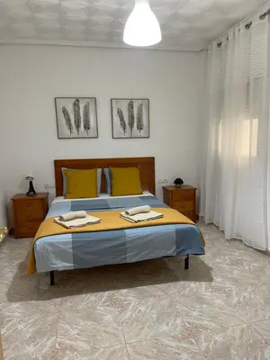 a bedroom with a bed with two towels on it at UIM Mediterraneo PB America Wifi in Puerto de Sagunto