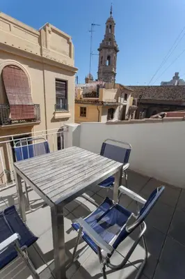 a wooden table and chairs on a balcony at Atico Tapineria in Valencia