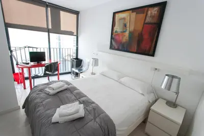 a bedroom with a bed with two towels on it at Atico Tapineria in Valencia