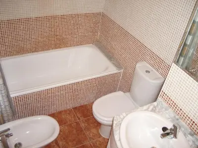 a bathroom with a white toilet and a sink at MAGNIFICO ATICO-DUPLEX FRENTE AL MAR in El Puig