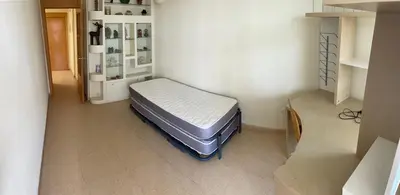 a bedroom with a bed in the corner of a room at MAGNIFICO ATICO-DUPLEX FRENTE AL MAR in El Puig