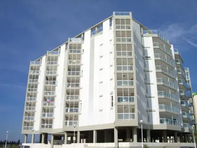 a large white apartment building on a clear day at MAGNIFICO ATICO-DUPLEX FRENTE AL MAR in El Puig