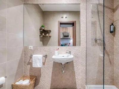 a bathroom with a sink and a shower at Livensa Living Studios Valencia Marina Real Hotel-Apartamento in Valencia