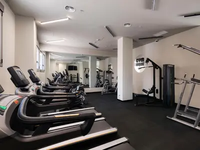 a row of treadmills in a gym with treadles at Livensa Living Studios Valencia Marina Real Hotel-Apartamento in Valencia