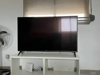 a large flat screen tv on a white stand at Attic Loft Gran Vía in Valencia