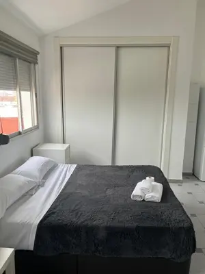 a bedroom with a bed with two towels on it at Attic Loft Gran Vía in Valencia