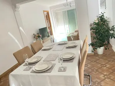 a white table with chairs and a white table cloth at Almudafer in Puerto de Sagunto