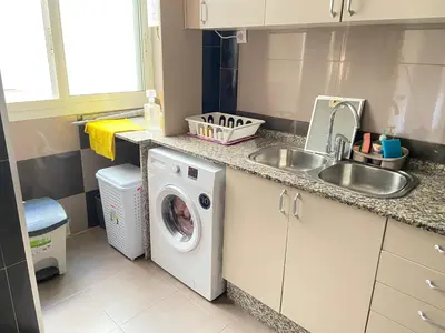 a kitchen with a washing machine and a sink at Almudafer in Puerto de Sagunto