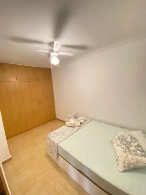 a bedroom with a bed and a ceiling fan at Almudafer in Puerto de Sagunto