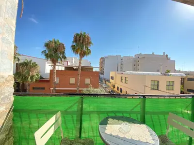 a balcony with a table and a view of a city at Almudafer in Puerto de Sagunto