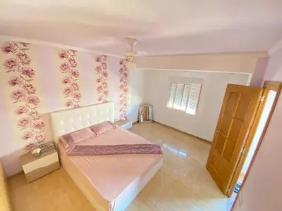 a small bedroom with a bed and a door at Almudafer in Puerto de Sagunto
