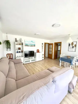 a living room with a large bed and a table at Apartamento Ciudamar in Puerto de Sagunto