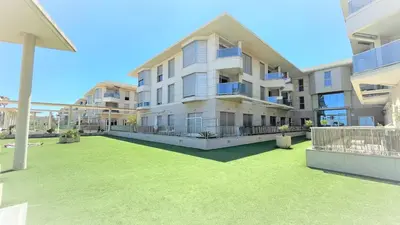 a large apartment building with a lawn in front of it at BEACH VALENCIA LUXURY - B40-21 - Apartament on Beach in Valencia