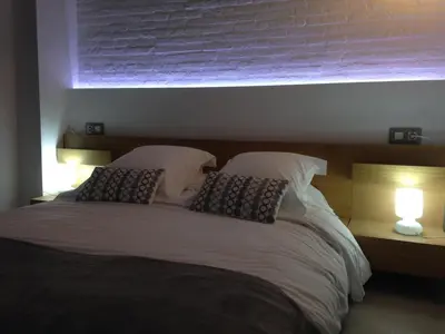 a bedroom with a bed with two pillows and a window at El 16 Ruzafa in Valencia