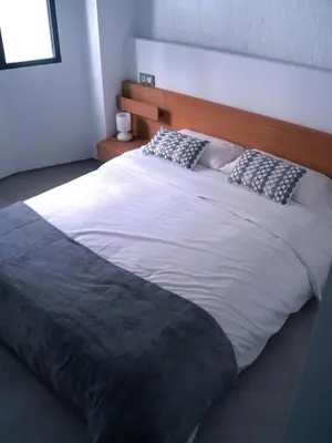 a large white bed with two pillows on it at El 16 Ruzafa in Valencia