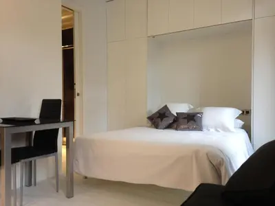 a bedroom with a white bed and a desk at El 16 Ruzafa in Valencia
