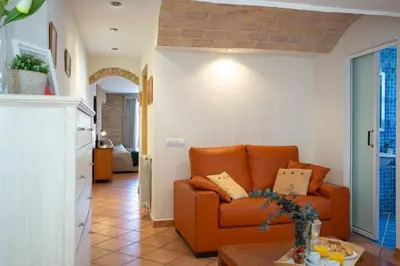 a living room with an orange couch and a table at SingularStays Valero in Valencia