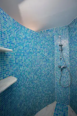 a blue bathroom with a shower with blue tiles at SingularStays Valero in Valencia
