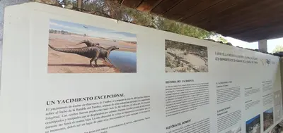 a display with a dinosaur model on a wall at La Chirrichana in Bicorp