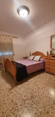 a bedroom with a large bed and a dresser at La Chirrichana in Bicorp