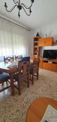 a living room with a table and chairs and a television at La Chirrichana in Bicorp