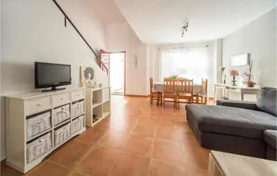 a living room with a couch and a tv at 2 Bedroom Pet Friendly Home In Sagunto in Sagunto