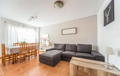 a living room with a couch and a table at 2 Bedroom Pet Friendly Home In Sagunto in Sagunto
