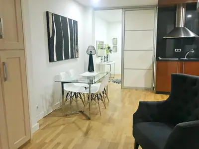 a dining room with a table and white chairs at APARTAMENTO JUNTO AYUNTAMIENTO DE VALENCIA in Valencia