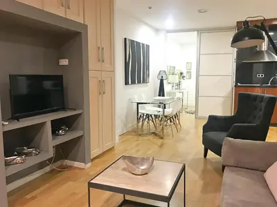 a living room with a couch and a table at APARTAMENTO JUNTO AYUNTAMIENTO DE VALENCIA in Valencia