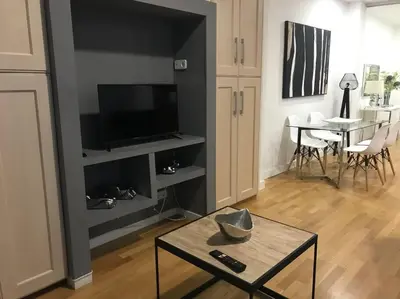 a living room with a tv and a table at APARTAMENTO JUNTO AYUNTAMIENTO DE VALENCIA in Valencia