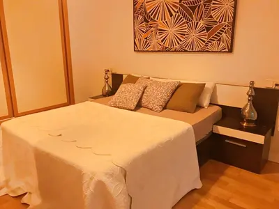 a bedroom with a bed and a painting on the wall at APARTAMENTO JUNTO AYUNTAMIENTO DE VALENCIA in Valencia