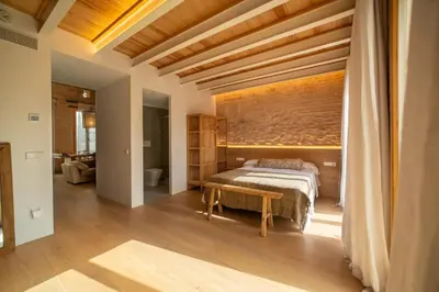 a bedroom with a large bed with a wooden wall at Design Loft near the sea in Valencia