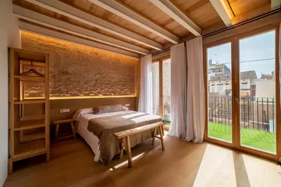 a mirror in a room with a bed and a bench at Design Loft near the sea in Valencia