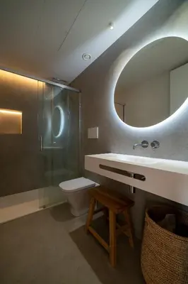 a bathroom with a shower with a mirror and a light at Design Loft near the sea in Valencia