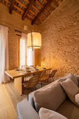 a dining room with a table and chairs and a couch at Design Loft near the sea in Valencia