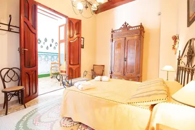 a bedroom with a large bed in a room at Global Vacacional, Bonita casa rural en Quart de les Valls in Cuart de les Valls