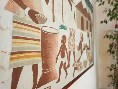 a painting of a woman and a cylinder on a wall at Global Vacacional, Bonita casa rural en Quart de les Valls in Cuart de les Valls