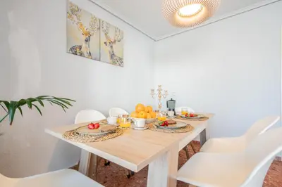 a dining room with a wooden table with fruit on it at Apartamento Familiar en Avenida del Puerto in Valencia