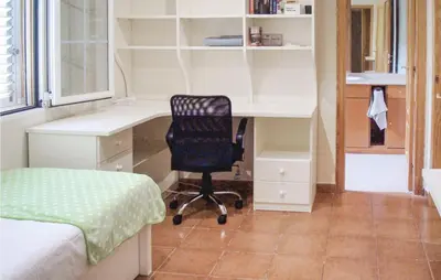 a bedroom with a desk and a chair at Amazing Home In Riba-Roja De Túria in Riba-Roja De Turia