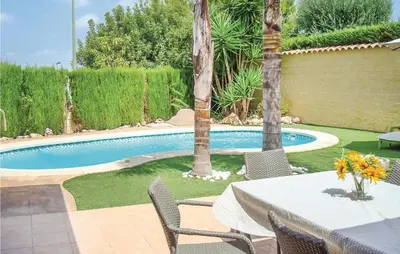 a patio with a table and chairs next to a pool at Amazing Home In Riba-Roja De Túria in Riba-Roja De Turia
