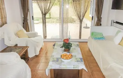 a living room with a bowl of fruit on a table at Amazing Home In Riba-Roja De Túria in Riba-Roja De Turia
